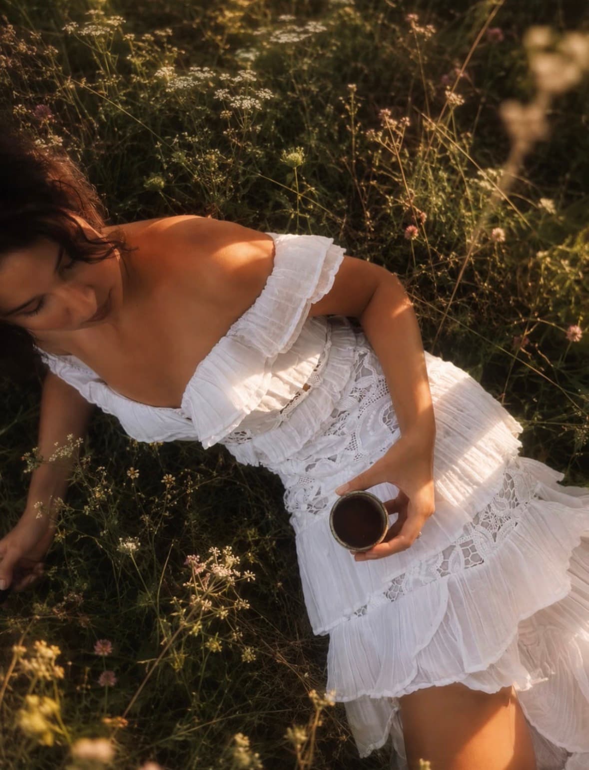 Sitting among wildflowers with the same cup, seen from above